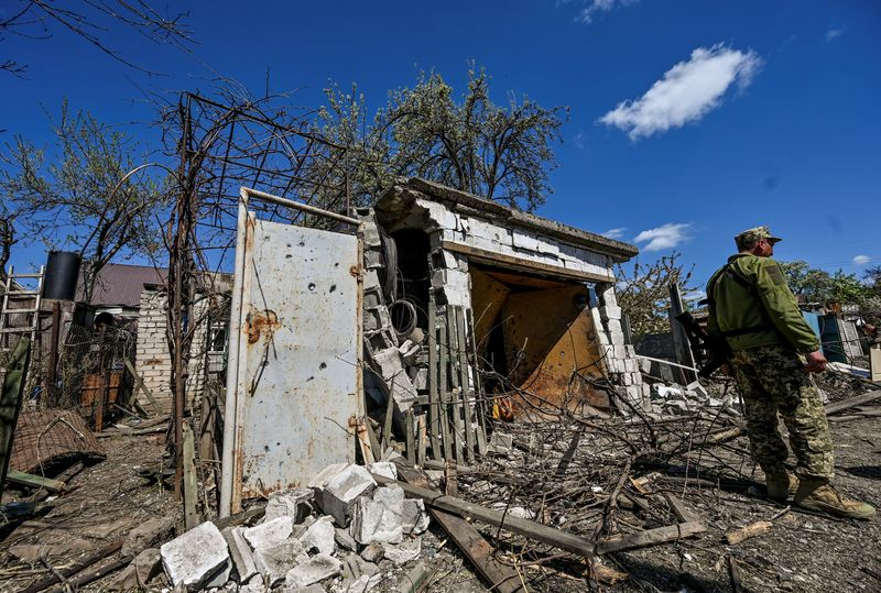 &copy; Reuters. Foto del jueves de un militar ucraniano junto a los restos de una casa en Zaporizhzhia
Abril 28, 2022.  REUTERS/Stringer