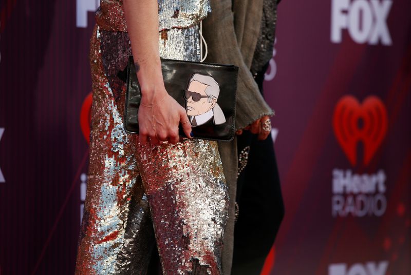&copy; Reuters. FILE PHOTO: Singer Steven Tyler and Aimee Preston, carrying a bag with an image of Karl Lagerfeld, arrive for the iHeartRadio Music Awards in Los Angeles, California, U.S., March 14, 2019. REUTERS/Mario Anzuoni/File Photo