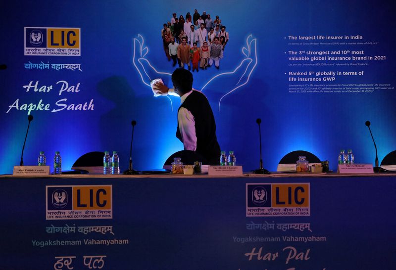 &copy; Reuters. FILE PHOTO: A man cleans a hoarding of Life Insurance Corporation of India (LIC) before the start of a news conference about the LIC initial public offering (IPO) launch, in Kolkata, India, April 29, 2022. REUTERS/Rupak De Chowdhuri/File Photo