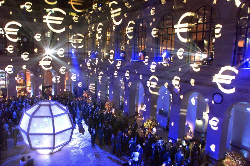 &copy; Reuters. FILE PHOTO: A multitude of the new euro currency symbols are projected on the walls of the Paris Bourse (stock exchange) during a gala evening to mark the first day of trading in the new European currency