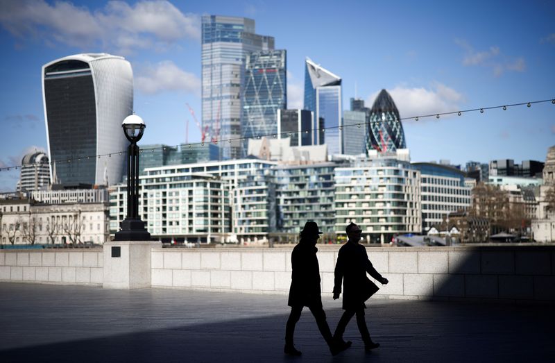 &copy; Reuters. FILE PHOTO: The City of London financial district can be seen as people walk along the south side of the River Thames, amid the coronavirus disease (COVID-19) outbreak in London, Britain, March 19, 2021. REUTERS/Henry Nicholls