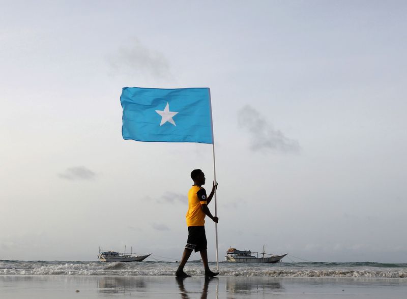 &copy; Reuters. شاب صومالي يرفع علم البلاد عند ساحل ليدو في صورة من أرشيف رويترز