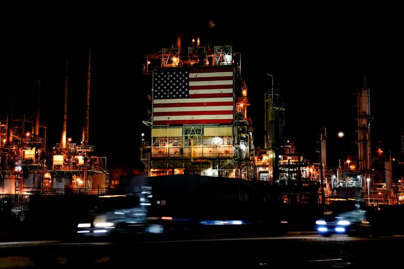 &copy; Reuters. FILE PHOTO: Semi trucks drive past a giant U.S. flag displayed at Marathon Petroleum's Los Angeles Refinery in Carson, California, U.S., March 11, 2022. Picture taken with long exposure. REUTERS/Bing Guan