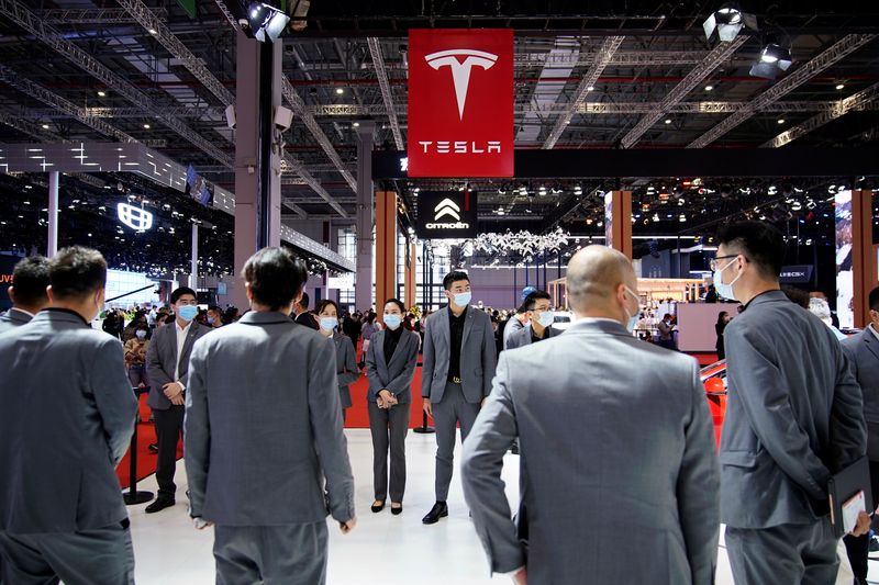 &copy; Reuters. Staff members stand at the Tesla booth during a media day for the Auto Shanghai show in Shanghai, China April 19, 2021. REUTERS/Aly Song/Files