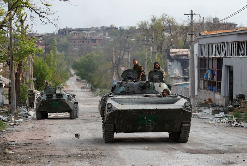 &copy; Reuters. أفراد من القوات التابعة لروسيا على مركبات عسكرية للجنود قرب مصنع آزوفستال للصلب في مدينة ماريوبول الساحلية في جنوب أوكرانيا يوم الخميس. تصو