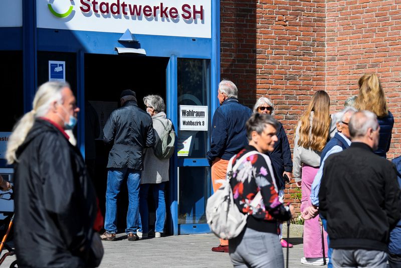 © Reuters. People wait outside a pooling station during Schleswig-Holstein state elections, in Eckernfoerde, Germany, May 8, 2022. REUTERS/Fabian Bimmer