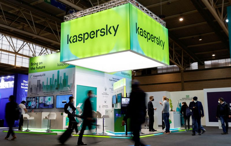 &copy; Reuters. FILE PHOTO: People walk next to Russian Kaspersky stand during the GSMA's 2022 Mobile World Congress (MWC), in Barcelona, Spain, March 2, 2022. REUTERS/ Albert Gea