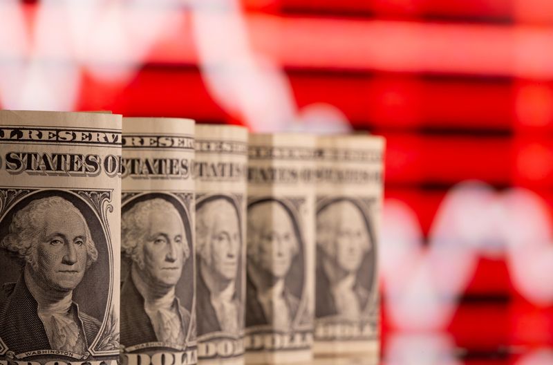 &copy; Reuters. U.S. one dollar banknotes are seen in front of displayed stock graph in this illustration taken February 8, 2021. REUTERS/Dado Ruvic/Illustration