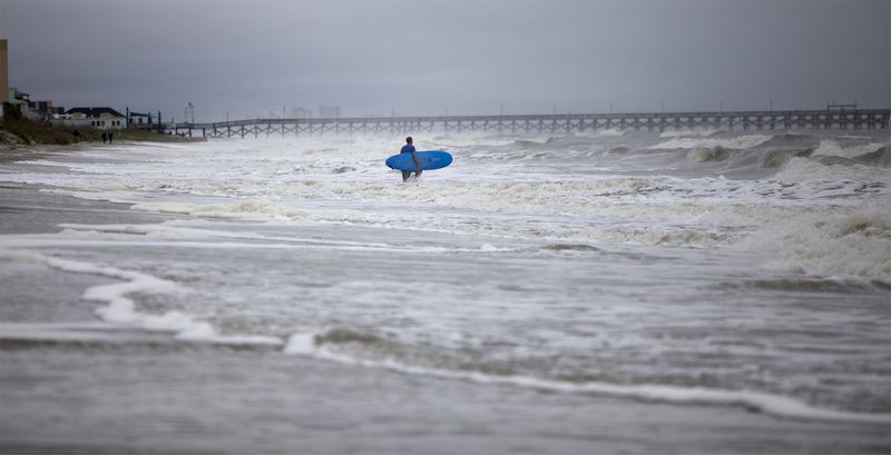 &copy; Reuters. A surfer navigates the wave in Surfside Beach, South Carolina, October 2, 2015.  REUTERS/Randall Hill  