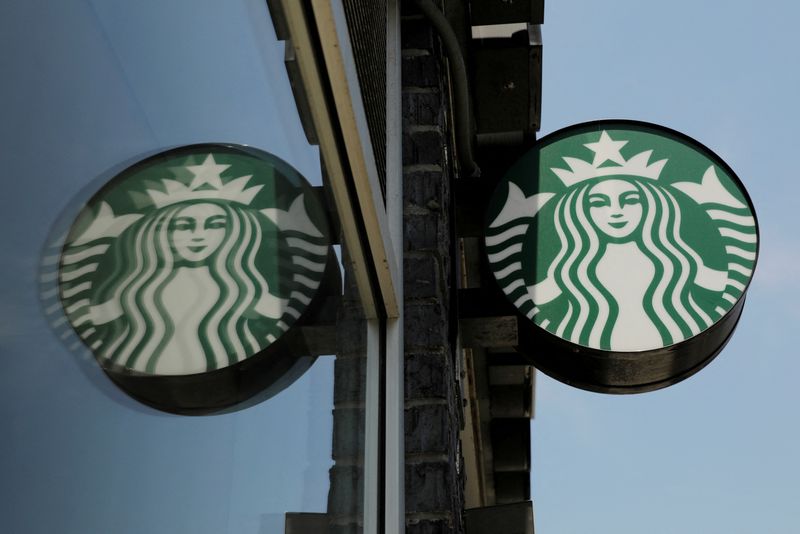 &copy; Reuters. FILE PHOTO: A Starbucks logo hangs outside of one of the 8,000 Starbucks-owned American stores that will close around 2 p.m. local time on Tuesday as a first step in training 175,000 employees on racial tolerance in the Brooklyn borough of New York, U.S.,