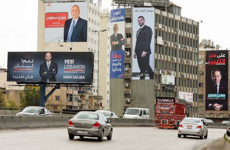 &copy; Reuters. Cars pass near electoral campaign billboards of candidates running for Lebanon's parliamentary election, in Dora, Lebanon May 9, 2022. Picture taken May 9, 2022. REUTERS/Mohamed Azakir