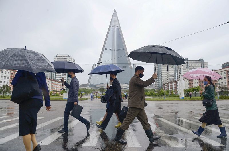 &copy; Reuters. FILE PHOTO: People wearing protective face masks walk amid concerns over the new coronavirus disease (COVID-19) in Pyongyang, North Korea May 15, 2020, in this photo released by Kyodo. Mandatory credit Kyodo/via REUTER/File Photo