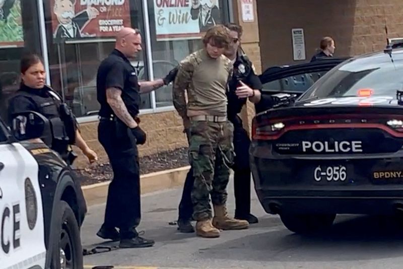 &copy; Reuters. A man is detained following a mass shooting in the parking lot of TOPS supermarket, in a still image from a social media video in Buffalo, New York, U.S. May 14, 2022.  Courtesy of BigDawg/ via REUTERS 