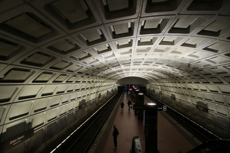 &copy; Reuters. FILE PHOTO: A few subway riders stand on the platform, normally bustling with rush hour commuters, at the Union Station Metro station in Washington, U.S. March 16, 2020.  REUTERS/Jonathan Ernst