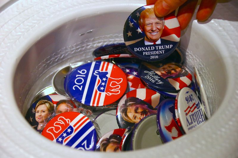 &copy; Reuters. FILE PHOTO: A guest at an event called the U.S. Presidential Election Watch, organised by the U.S. Consulate, reaches for a badge from out of a hat displaying photographs of Republican candidate Donald Trump and Democratic candidate Hillary Clinton, in Sy