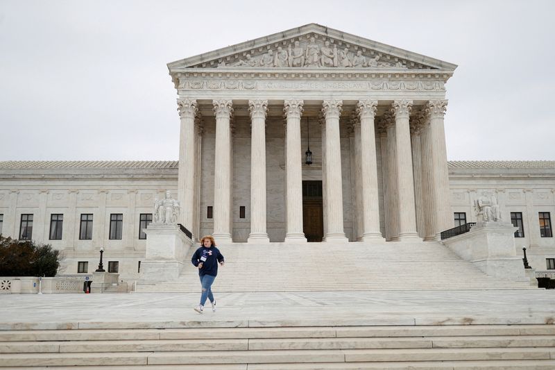 &copy; Reuters. FILE PHOTO: A visitor runs across the Supreme Court Plaza while attempting to catch their school group, at the U.S. Supreme Court on Capitol Hill in Washington, U.S., February 22, 2022. REUTERS/Tom Brenner