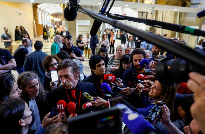 &copy; Reuters. Members of the rock group "Eagles of Death Metal", singer Jesse Hughes and former guitarist Eden Galindo speak to the media as they are at the Paris courthouse for the trial of the Paris' November 2015 attacks on the Ile de la Cite, in Paris, France, May 