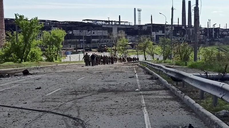 &copy; Reuters. Service members of Ukrainian forces who have surrendered after weeks holed up at Azovstal steel works leave the territory of the plant in Mariupol, Ukraine, in this still image taken from a video released May 18, 2022. Russian Defence Ministry/Handout via