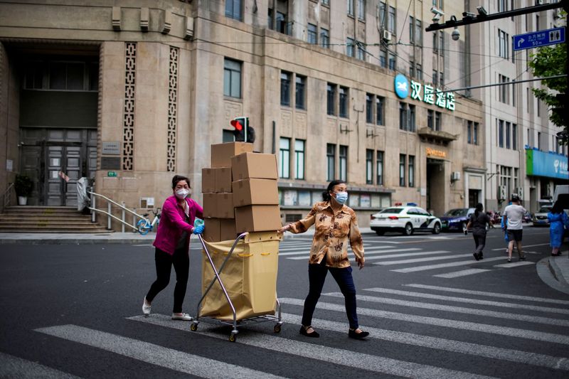 &copy; Reuters. Women carry boxes of food on a street during lockdown, amid the coronavirus disease (COVID-19) outbreak, in Shanghai, China, May 18, 2022. REUTERS/Aly Song