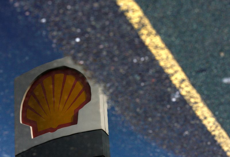 &copy; Reuters. FILE PHOTO: A Shell petrol station sign is reflected in a puddle in London April 28, 2009. The photograph has been rotated 180 degrees. REUTERS/Luke MacGregor