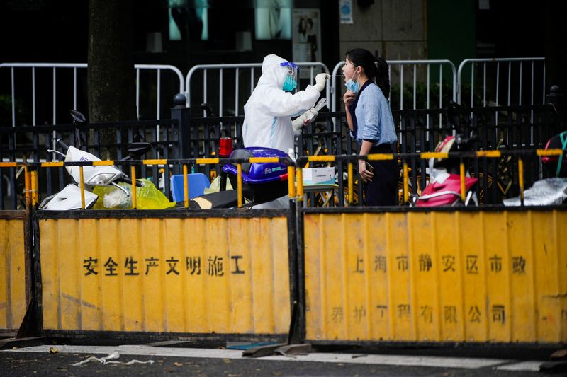 Locked-down Shanghai finds new cases, breaking 