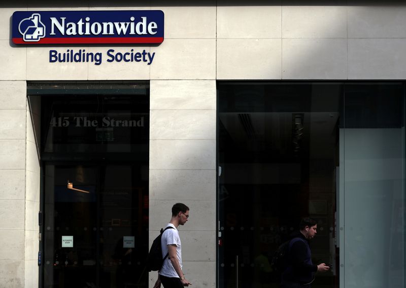 &copy; Reuters. FILE PHOTO: A man walks past a Nationwide Building Society in London, Britain, May 22, 2019. REUTERS/Hannah McKay