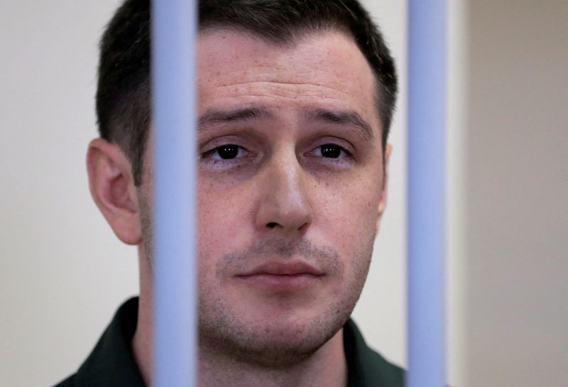&copy; Reuters. FILE PHOTO: U.S. ex-Marine Trevor Reed, who was detained in 2019 and accused of assaulting police officers, stands inside a defendants' cage during a court hearing in Moscow, Russia March 11, 2020. REUTERS/Tatyana Makeyeva