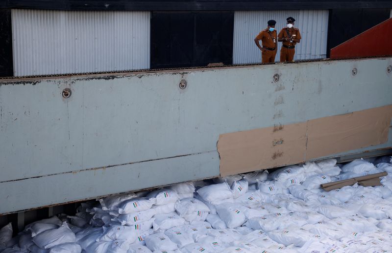&copy; Reuters. Members of security personnel stand on a cargo ship carrying essential supplies of rice, milk and some critically needed medicines from India, amid Sri Lanka's economic crisis, at a port in Colombo, Sri Lanka, May 22, 2022. Picture taken on May 22, 2022. 