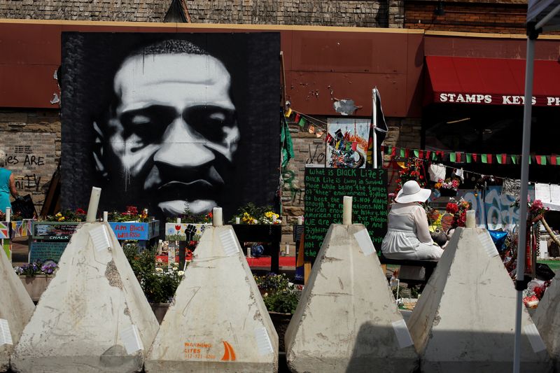&copy; Reuters. FILE PHOTO: Murals, flowers, and offerings sit behind barricades moved by city employees after reopening of George Floyd Square began, the area where George Floyd was killed in Minneapolis police custody the year before, in Minneapolis, Minnesota, U.S. Ju
