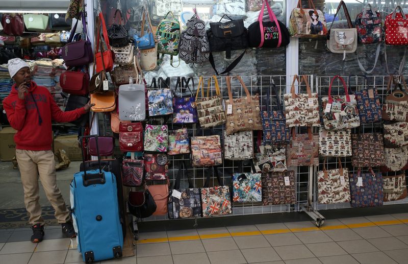 &copy; Reuters. FILE PHOTO: A worker waits for customers at a clothing store in Johannesburg, South Africa, June 9, 2017. REUTERS/Siphiwe Sibeko