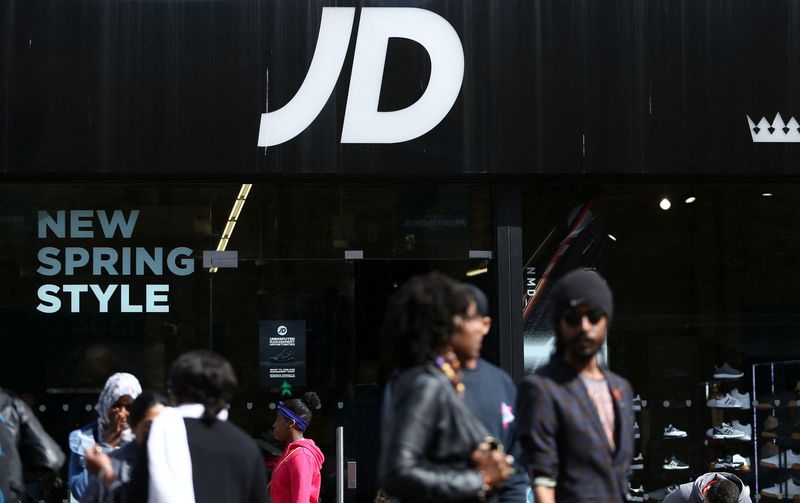 &copy; Reuters. FILE PHOTO: People pass a JD Sports store in London, Britain April 11, 2017.  REUTERS/Neil Hall