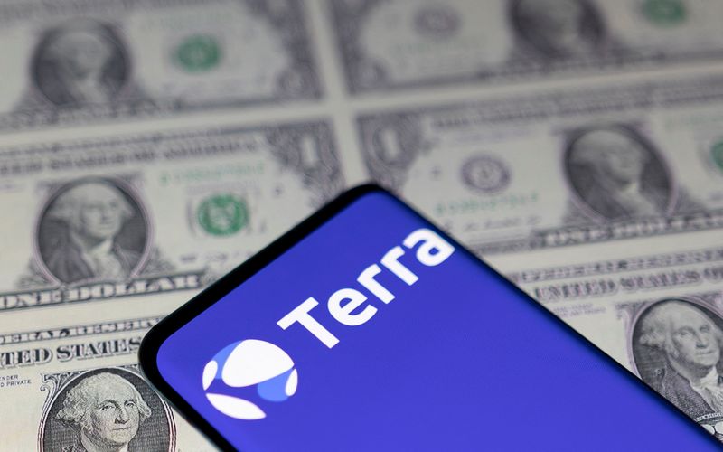 &copy; Reuters. Smartphone with Terra logo is placed on displayed U.S. dollars in this illustration taken May 11, 2022. Illustration taken May 11, 2022. REUTERS/Dado Ruvic/Illustration/Files