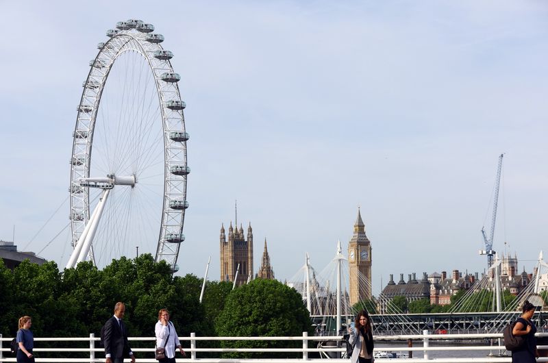 &copy; Reuters. FILE PHOTO: People walk across Waterloo Bridge during the morning rush hour in London, Britain, May 18, 2022. REUTERS/Hannah McKay