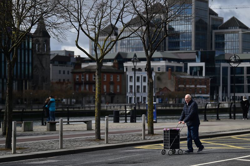 &copy; Reuters. FILE PHOTO: A man pushes a trolley across the road in the Irish Financial Services Centre (IFSC), in Dublin, Ireland, April 2, 2022. REUTERS/Clodagh Kilcoyne