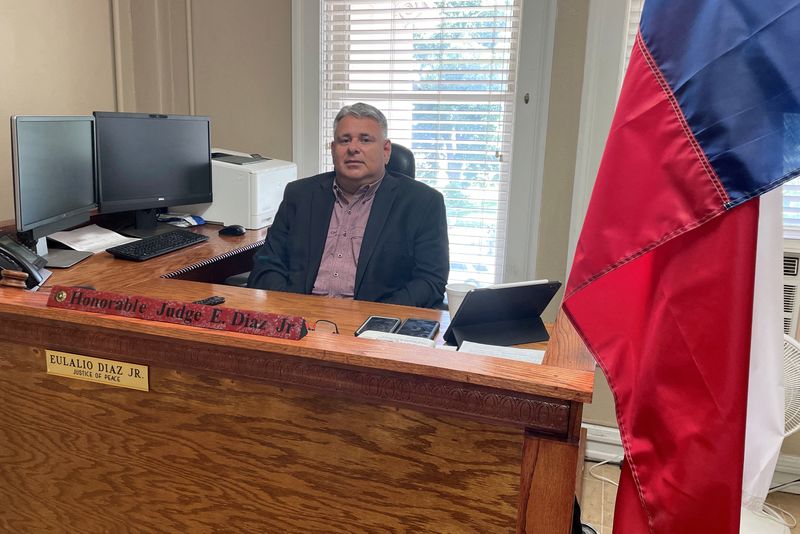 © Reuters. Uvalde's Justice of the Peace Eulalio Diaz Jr., 49, poses at his desk in the Uvalde County Courthouse building in Uvalde, Texas, U.S., May 25, 2022. Picture taken May 25, 2022.  REUTERS/Brad Brooks