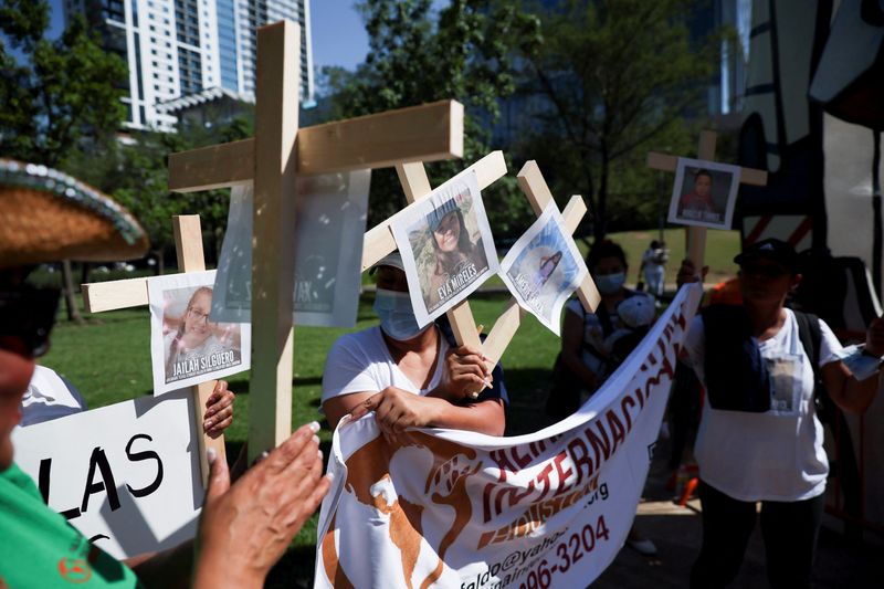 &copy; Reuters. People hold pictures of victims of the Texas shooting as they protest against gun laws outside the National Rifle Association (NRA) annual convention in Houston, Texas, U.S. May 27, 2022. REUTERS/Shannon Stapleton