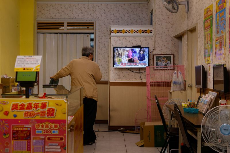 &copy; Reuters. A lottery store staff member watches the evening news in Hualien, Taiwan April 8, 2023. REUTERS/Ann Wang/File Photo