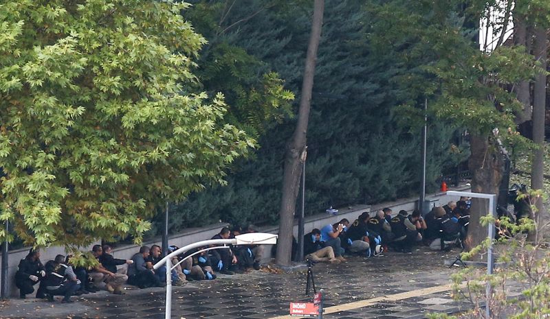 © Reuters. Members of the Turkish Police take cover as an unexploded bomb is detonated in front of the Interior Ministry following a bomb attack in Ankara, Turkey October 1, 2023. REUTERS/Cagla Gurdogan