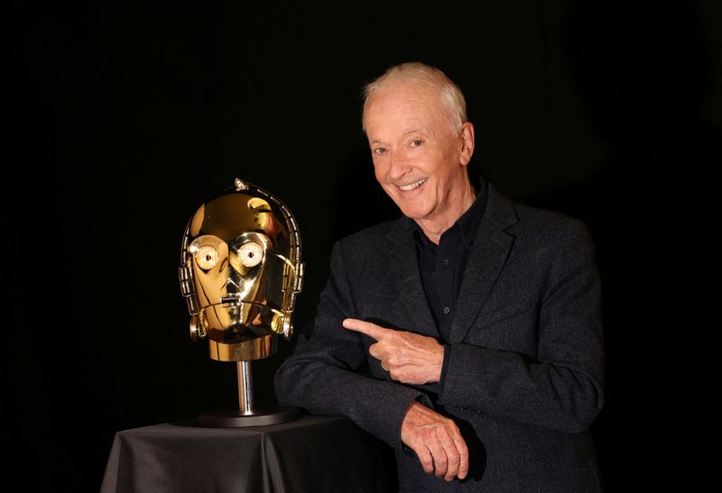 &copy; Reuters. Actor Anthony Daniels, who played C-3PO in 11 Star Wars films, poses next to a screen-matched, light-up C-3PO head from the 1977 film "Star Wars: A New Hope" which is part of his personal collection, at Propstore in Chenies, Britain, September 20, 2023. T