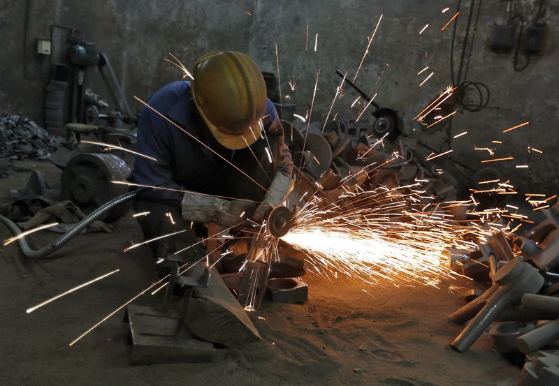 &copy; Reuters. A worker grinds a metal shaft metal used in water pumps at a manufacturing unit on the outskirts of the western Indian city of Ahmedabad June 2, 2014. REUTERS/Amit Dave/File Photo