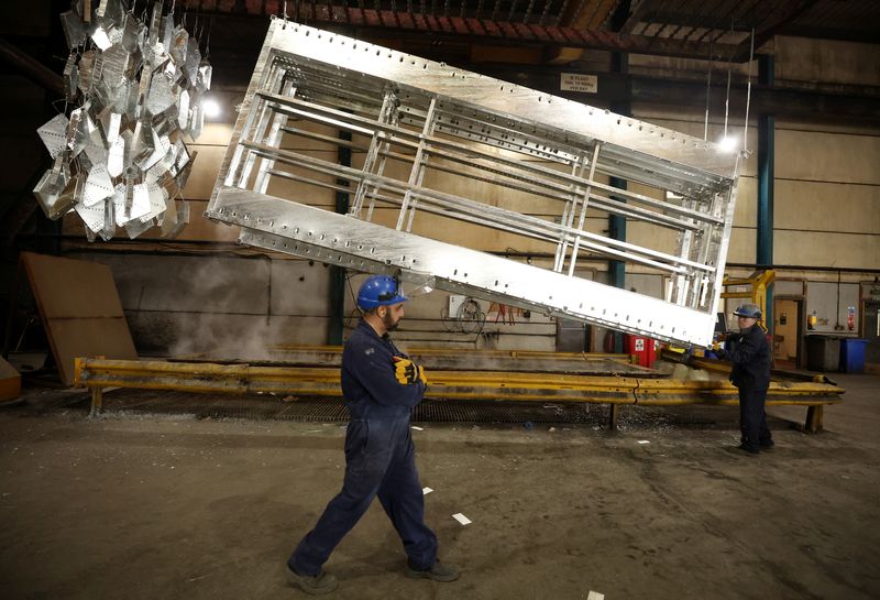 &copy; Reuters. FILE PHOTO: A worker walks past freshly galvanised pieces of metal inside the factory of Corbetts The Galvanizers in Telford, Britain, June 28, 2022. REUTERS/Phil Noble/File Photo