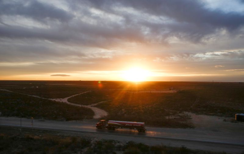 &copy; Reuters. The sun rises behind an oil tanker driving through the Permian Basin in Mentone, Texas, U.S., November 26, 2019. Picture taken November 26, 2019.  REUTERS/Angus Mordant/File Photo