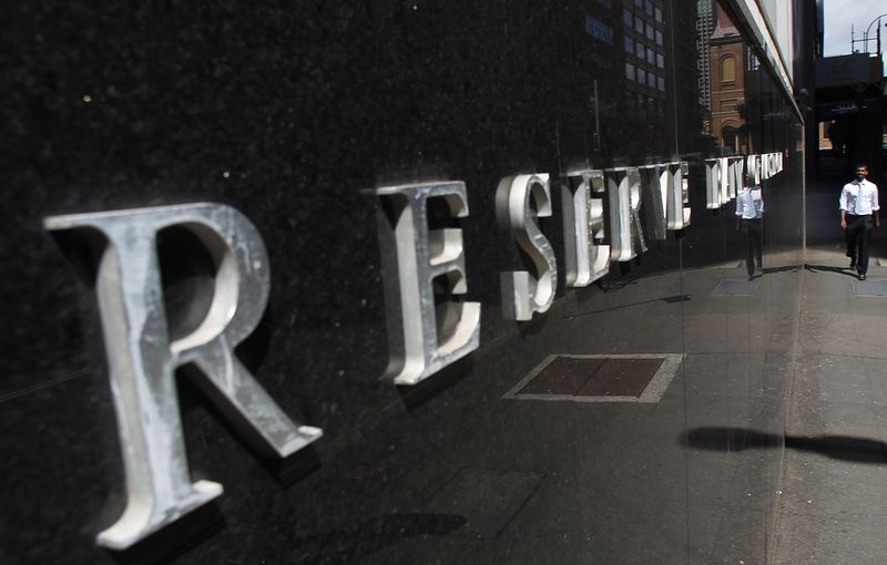 &copy; Reuters. An office worker walks past the Reserve Bank of Australia building in central Sydney October 5, 2010. REUTERS/Daniel Munoz/File Photo