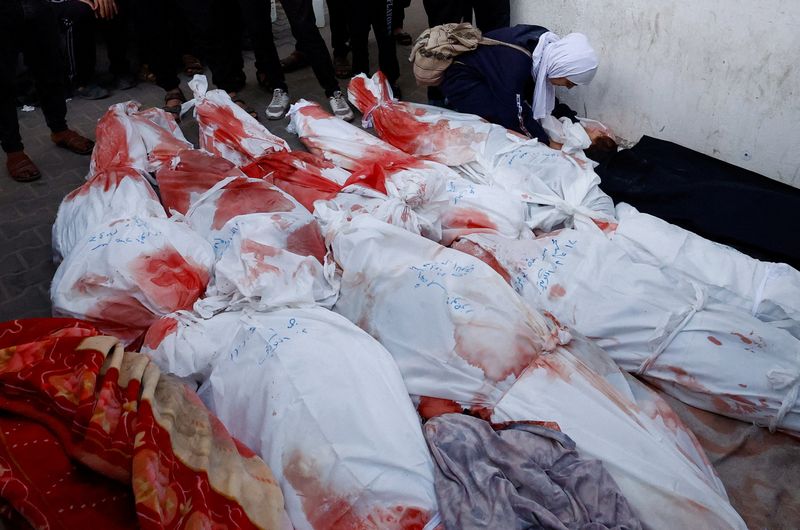 &copy; Reuters. FOTO DE ARCHIVO: Una mujer junto al cadáver de un niño y otros cuerpos de palestinos muertos en ataques israelíes, en el hospital Abu Yousef al-Najjar, en Ráfah, sur de la Franja de Gaza. 12 de febrero de 2024. REUTERS/Mohammed Salem