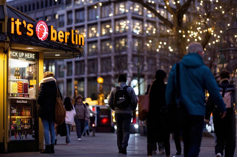 &copy; Reuters. FILE PHOTO: People walk next to a Doner kebab and Currywurst booth at Kurfuerstendamm shopping street during Christmas season in Berlin, Germany, December 18, 2023. REUTERS/Lisi Niesner/File Photo