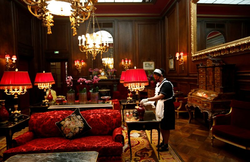 &copy; Reuters. FILE PHOTO: A cleaning lady wearing a protective face mask wipes dust in the lobby at the Sacher hotel in Vienna, Austria May 28, 2020.  REUTERS/Leonhard Foeger/File Photo