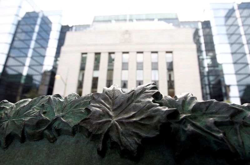 &copy; Reuters. FILE PHOTO: A sign framed by maple leaves is pictured in front of the Bank of Canada building in Ottawa July 17, 2012. REUTERS/Chris Wattie/File Photo