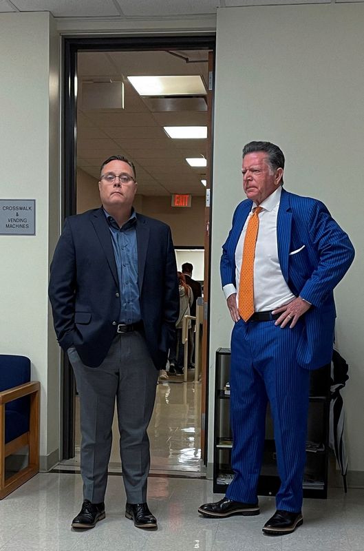 &copy; Reuters. FILE PHOTO: ExxonMobil Senior Vice President David R. Scott waits outside a Texas courtroom with defense attorney Dan Cogdell, in Conroe, Texas, U.S., October 25, 2023. REUTERS/Erwin Seba/File Photo