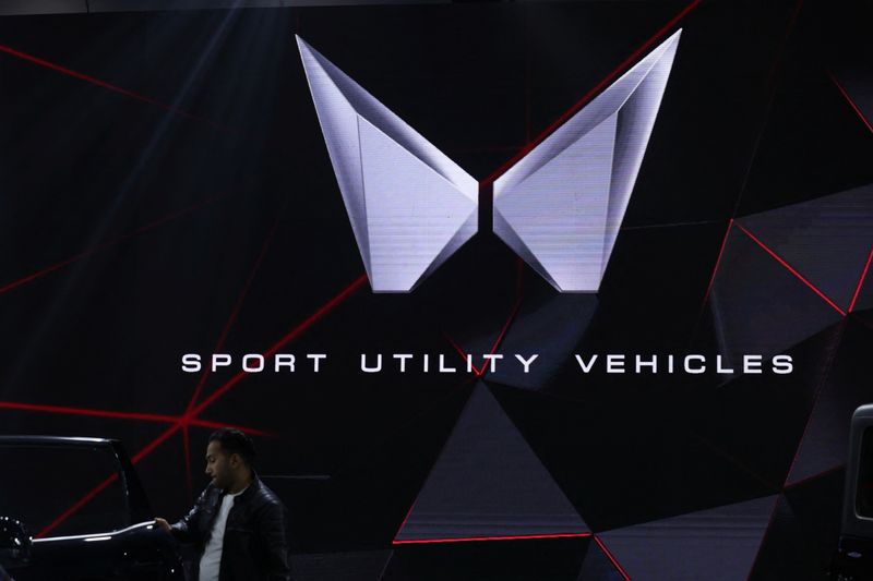 &copy; Reuters. FILE PHOTO: A man stands next to a screen displaying Mahindra's logo at Bharat Mobility Global Expo organised by India's commerce ministry at Pragati Maidan in New Delhi, India, February 1, 2024. REUTERS/Anushree Fadnavis/File Photo
