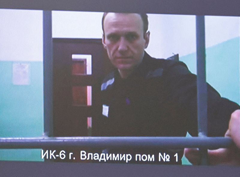 &copy; Reuters. FILE PHOTO: Russian opposition politician Alexei Navalny appears on a screen via video link from the IK-6 penal colony in the Vladimir region, during a court hearing to consider an appeal against his sentence in the criminal case on numerous charges, incl